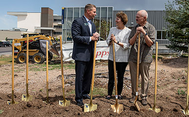LCCC President Dr. Joe Schaffer speaks with Dr. Sandra Surbrugg and her husband Dr. Bob Prentice at the groundbreaking ceremony for the Surbrugg Prentice Auditorium; the facility is scheduled to open this winter.