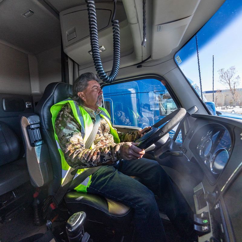 photo of a student driving a semi in the cab