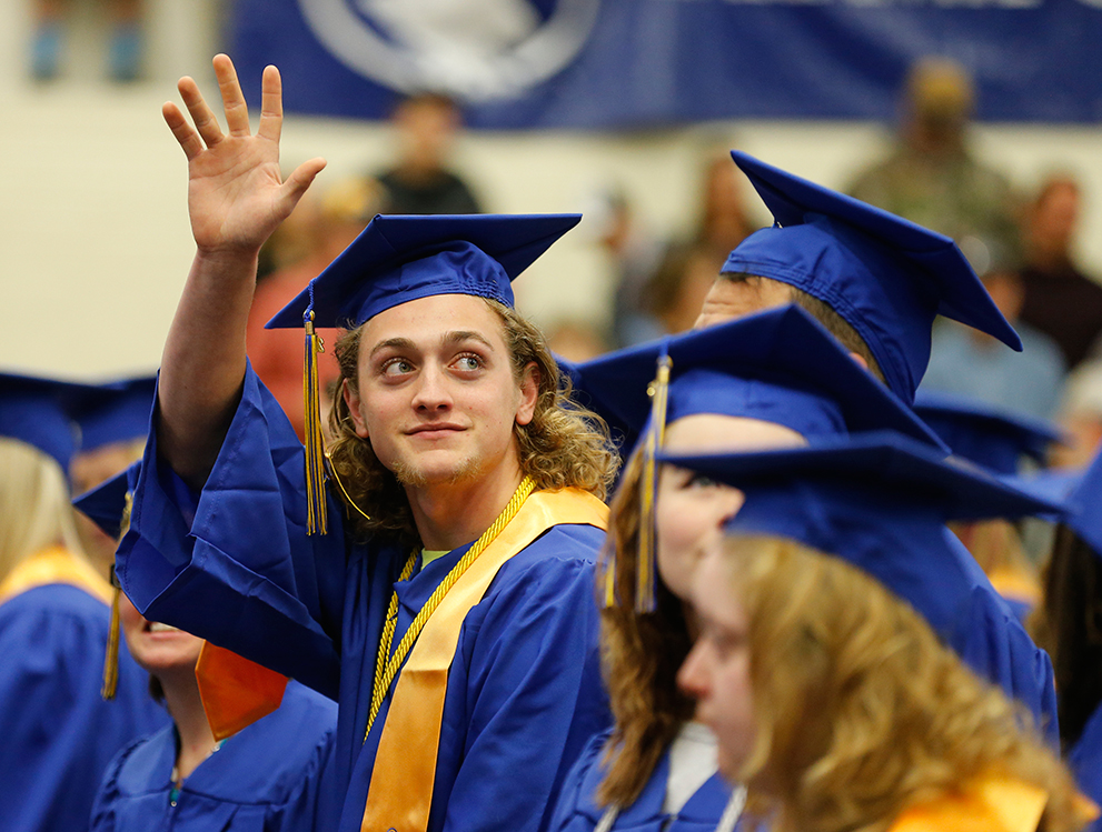 Student waving to family during LCCC's commencement ceremony.