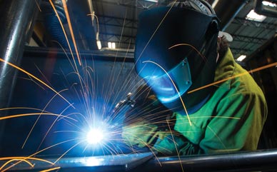 student welding at new Flex Tech building