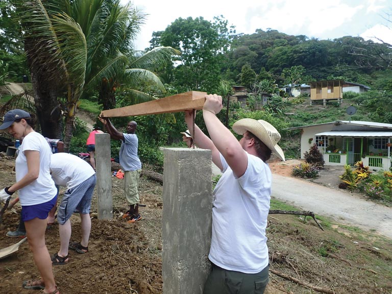 Robert Swank works with site foreman to lay the base of the tutoring center.