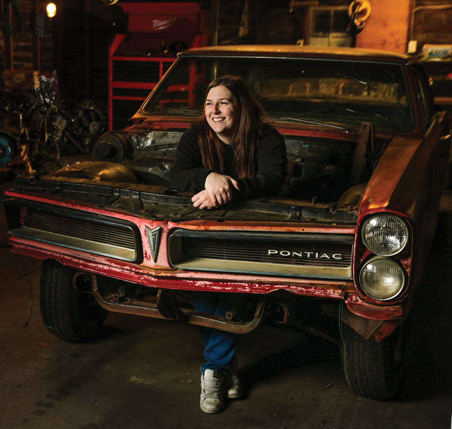 Allison Berard standing in a car frame