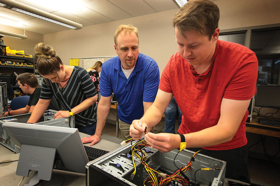 LCCC computer students working with wires in computers