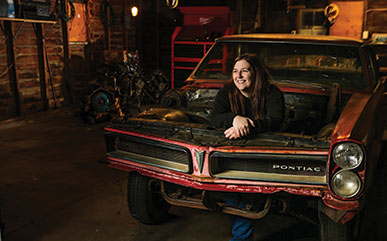 Allison Berard standing in a car frame