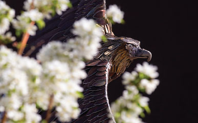 eagle sculpture with blooming trees