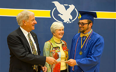 Stalcup winner at graduation with Mr. and Mr.s Stalcup