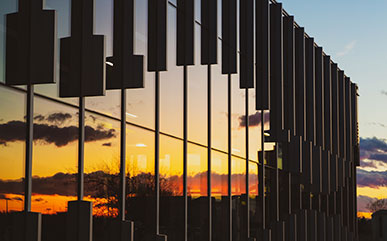 outside the Ludden Library in evening with sunset on windows