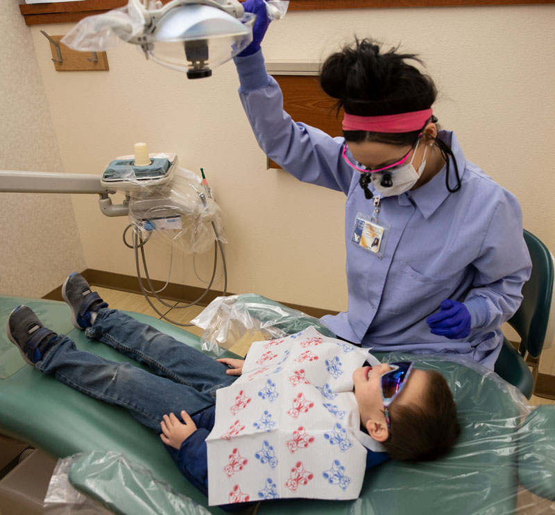 LCCC dental hygiene student Torrey Anaya examines Guadalupe Montoya during this year's Give Kids a Smile event.