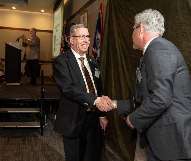 LCCC Foundation Board Member Bob Womack shakes hands with Lex Madden of Eastern Wyoming College; in February, Womack won the Foundation Volunteer of the Year Award from the Wyoming Association of Community College Trustees.