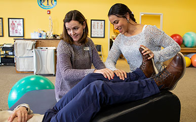 Physical therapist Mandy Keefe (left) guides LCCC student Nicole Johnson during a session at the Physical Therapy Center of Cheyenne.