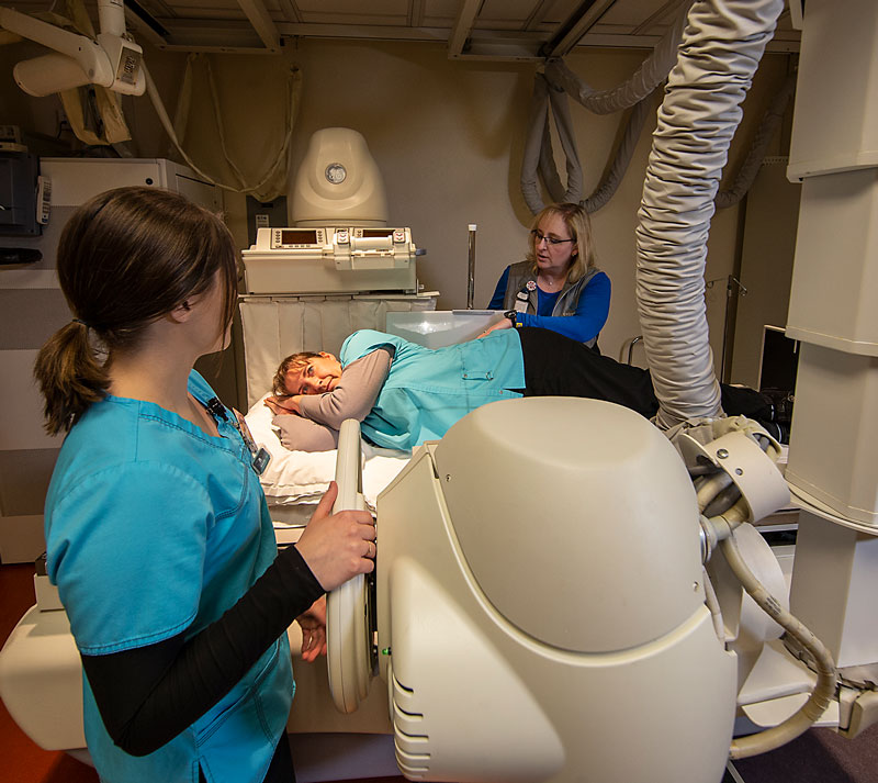LCCC radiography students Lindsey Underhill (left) and Lisa Hancock (center) practice positioning with Teri Bedwell of Cheyenne Radiology Group.