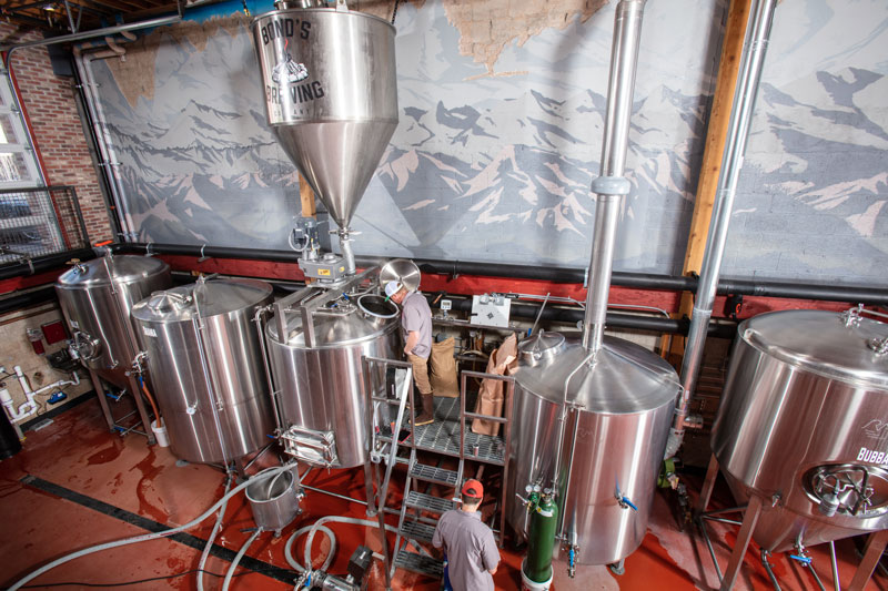 Bond’s Brewing Company owner  Jay Bond gets  ready to mash in 1,000 pounds of  malted barley with a view of all the equipment