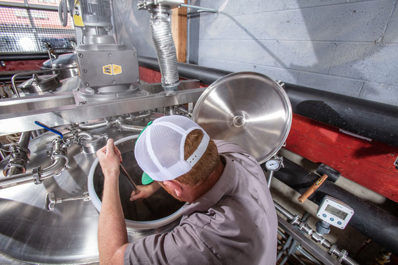 Bond’s Brewing Company owner  Jay Bond stirring in one of the machines