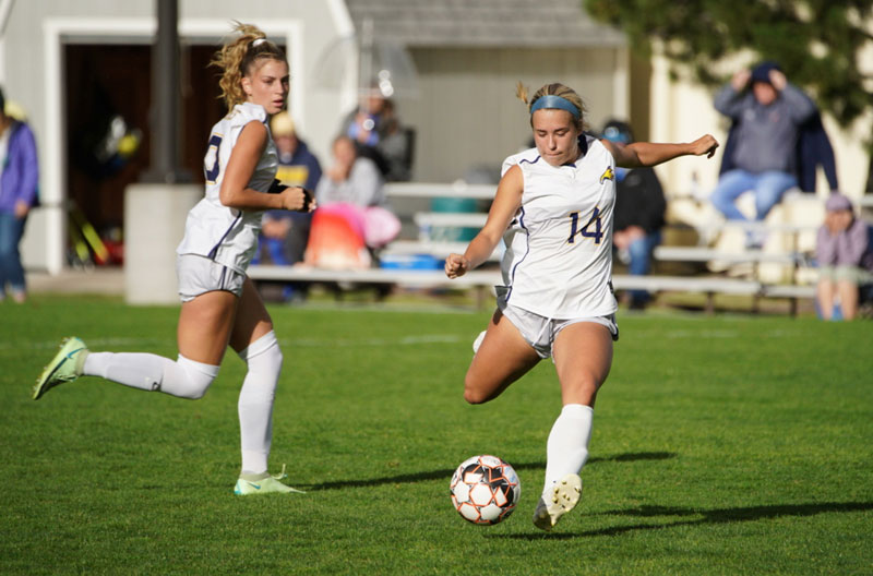 Women's Soccer freshman forward Caroline Kuhn kicking the soccer ball