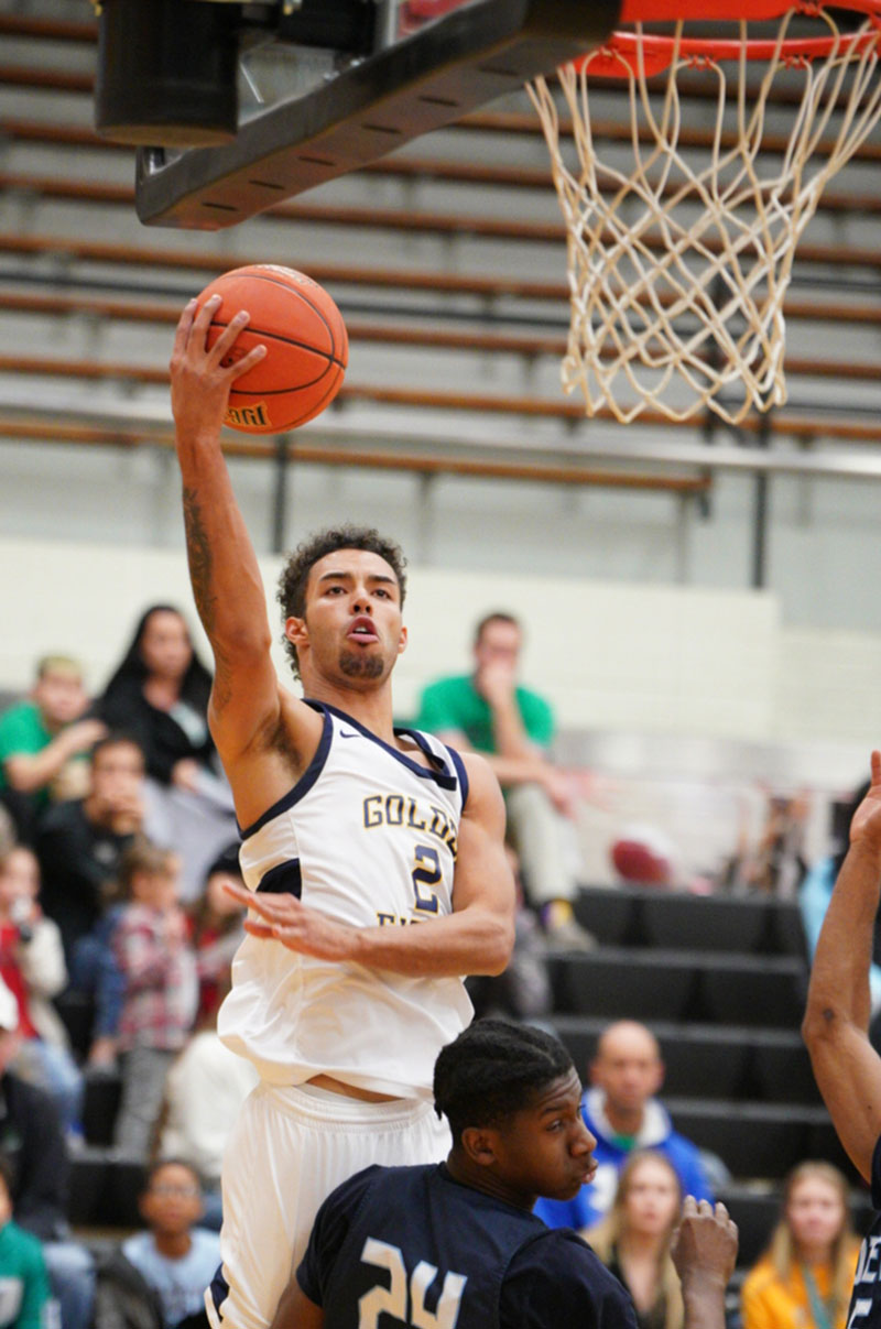 Xavier McCord of the men’s basketball team shooting a basket