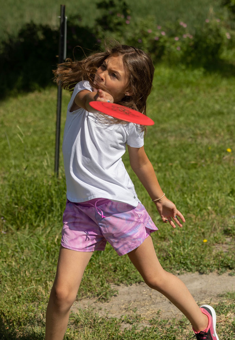 A student throwing a frisbee in a SEEK summer class