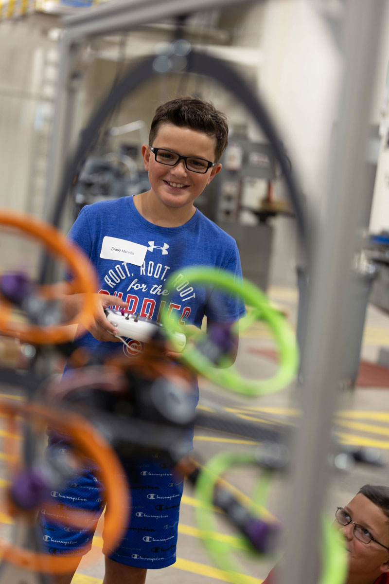 A student using a robot in a summer class in the Advanced Manufacturing & Material Center