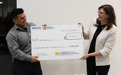 Alejandro holding a big check with Minden Fox