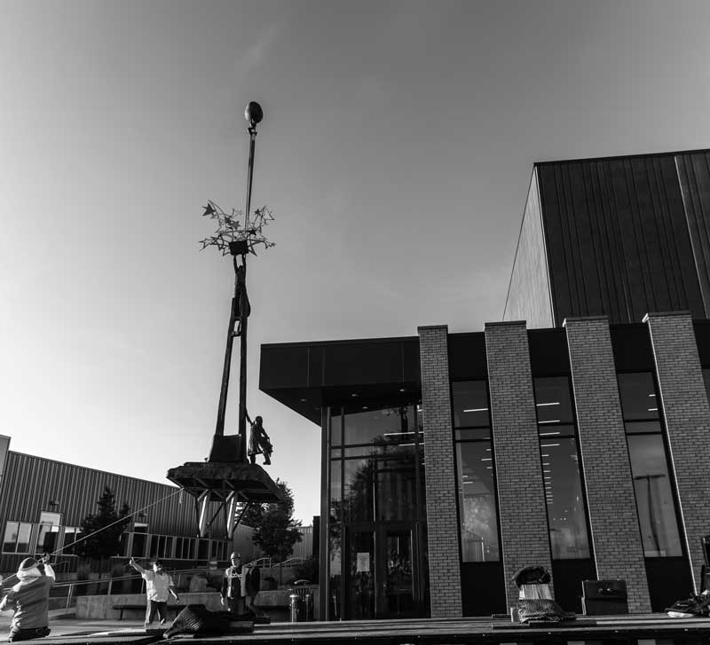 Image of the Dare to Dream statue being put in place on campus near the auditorium