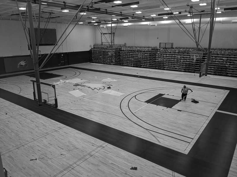 Photo of the new flooring being installed in the competition gym in the RAC