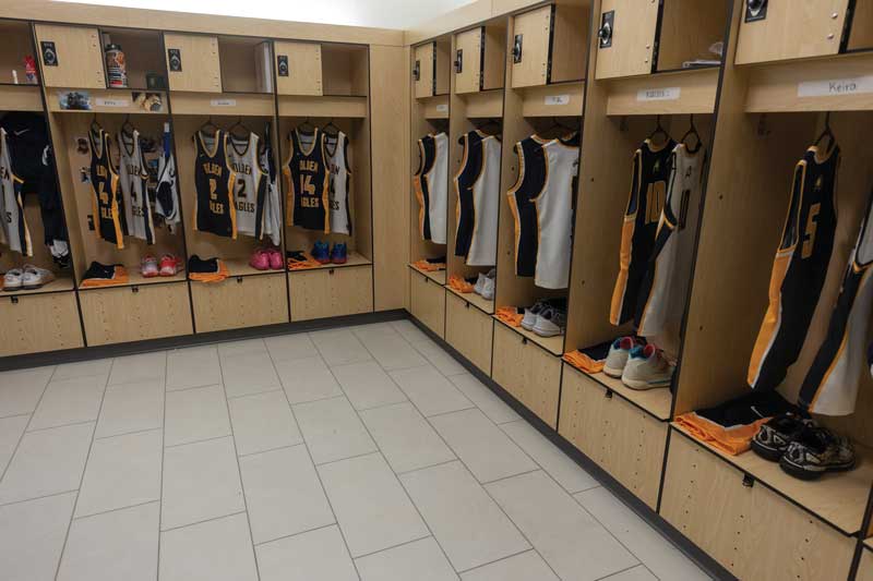 Inside a locker room in the newly renovated RAC with jerseys hanging for each player and shoes set out