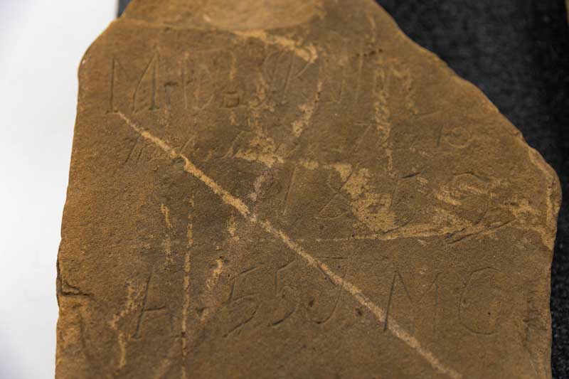 Close up of a grave stone grave marker with carvings