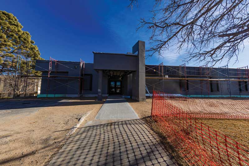 Exterior of the CCI building entrance under construction, mostly covered in a protective layer