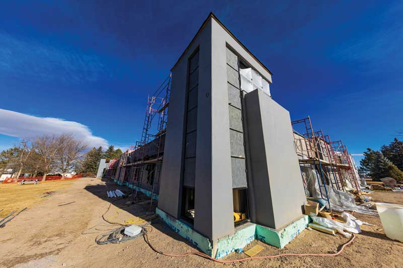 Corner of the CCI Building visible from the road during construction. Mostly covered in a protective layer.