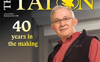 Magazine cover - Man standing front of building entrance.