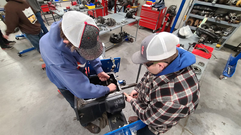 photograph of students tearing down a transmission in LCCC's Flex Tech building