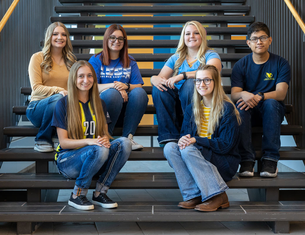 Group photo of student ambassadors sitting on stairs in the Clay Pathfinder Building