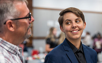 photo of a David First Generation student talking to a faculty member