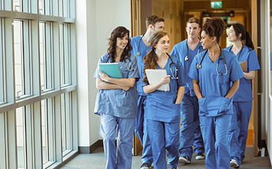 photo of a group in scrubs walking in a hallway