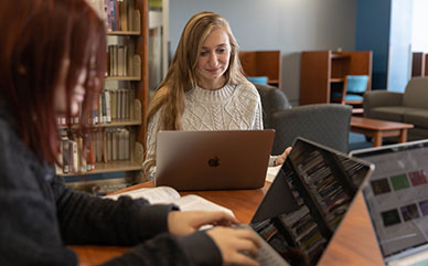 photo of two students studying with laptops in the Ludden Library