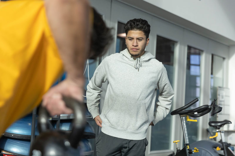 photo of exercise science student working with adult with weights