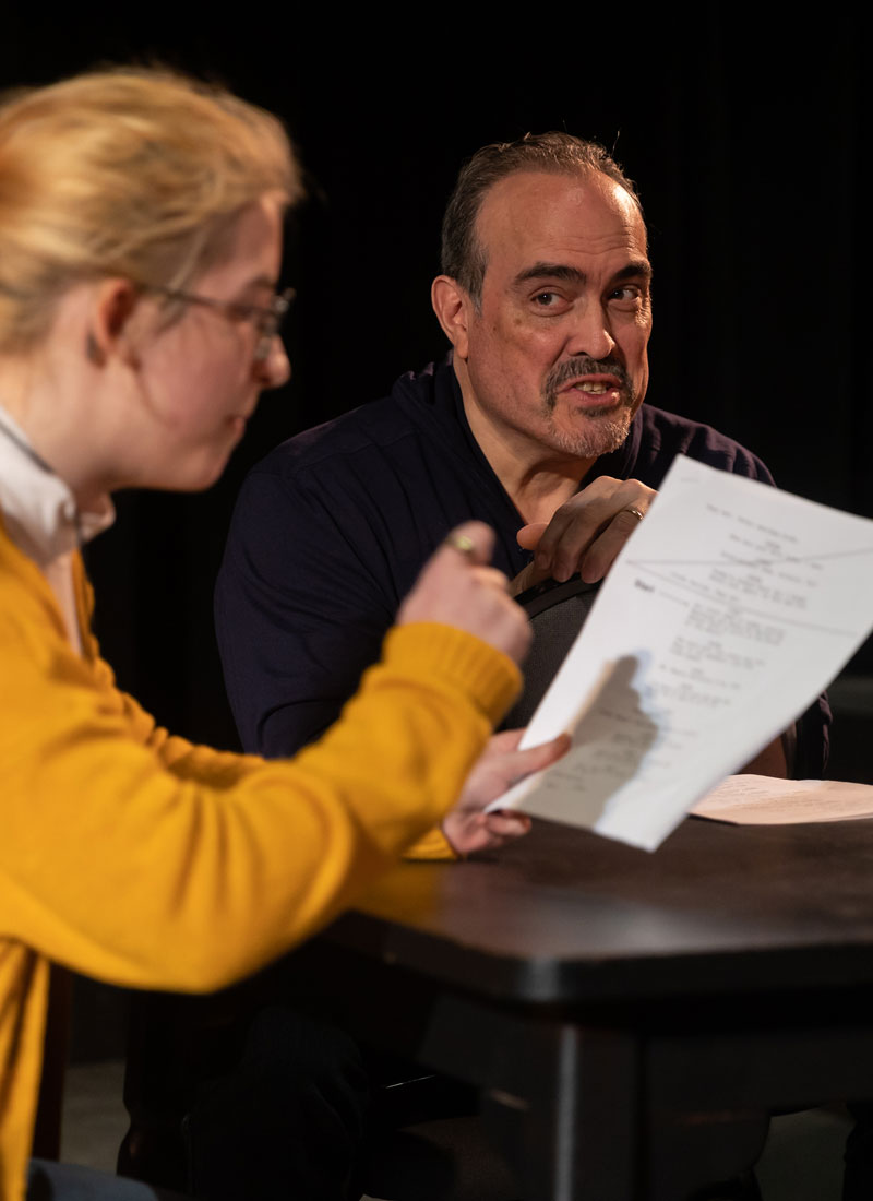 photo of David Zayas reading with an LCCC student on stage