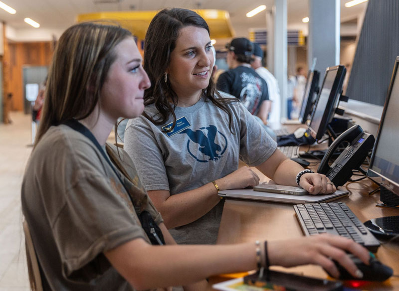 photo of LCCC staff helping a student at a computer