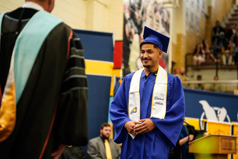 photo of a graduate walking across the stage