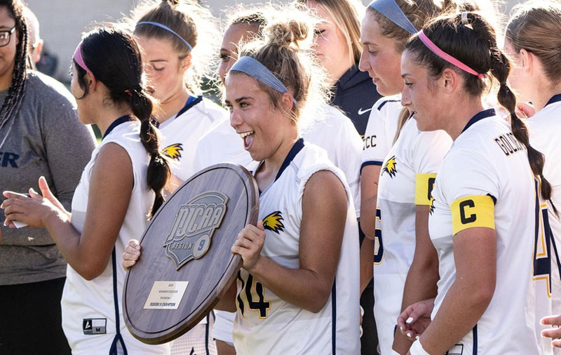 Photo of the LCCC women's team holding their region 9 champtionship plaque.