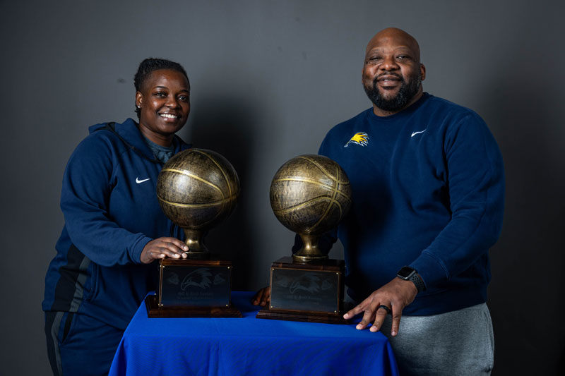 LCCC Basketball coaches with the Oil and Rail trophies