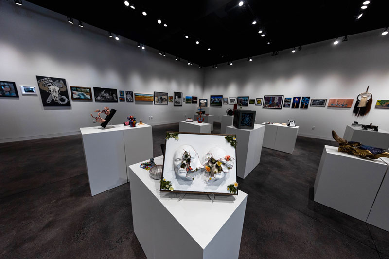 Photo showing the whole gallery with student art on the walls and on stands in the middle