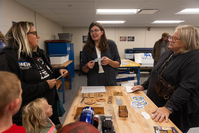 photo in the LCCC Concept Forge of people standing around a table looking at printed pieces.