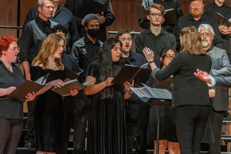 Choir on stage singing during a concert