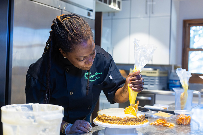 Petrina Peart decorates a cake.