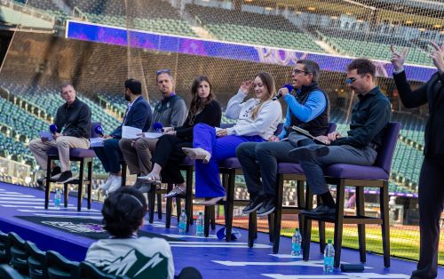 Panelists speak at Coors field during the Business of Baseball event.