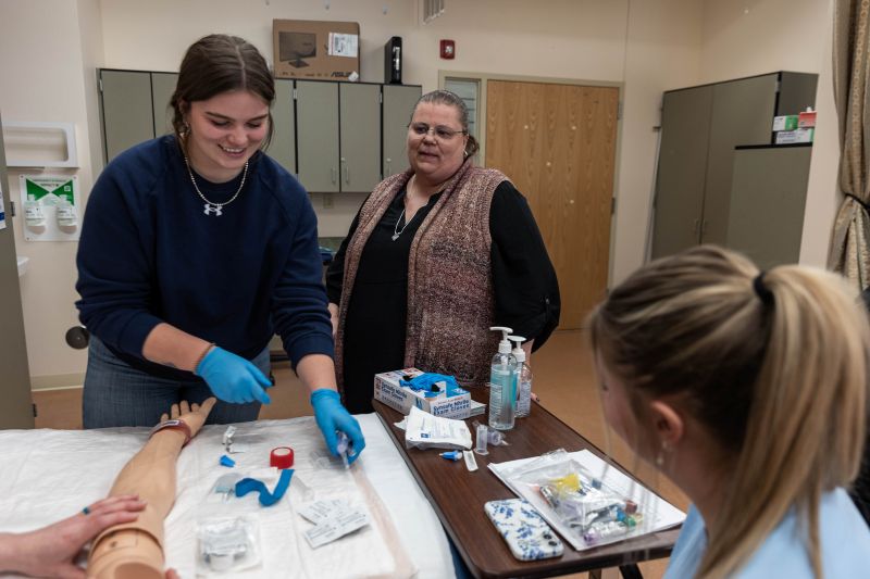 Jennifer Ackerman, LCCC Health Sciences program director, works with students in a lab.