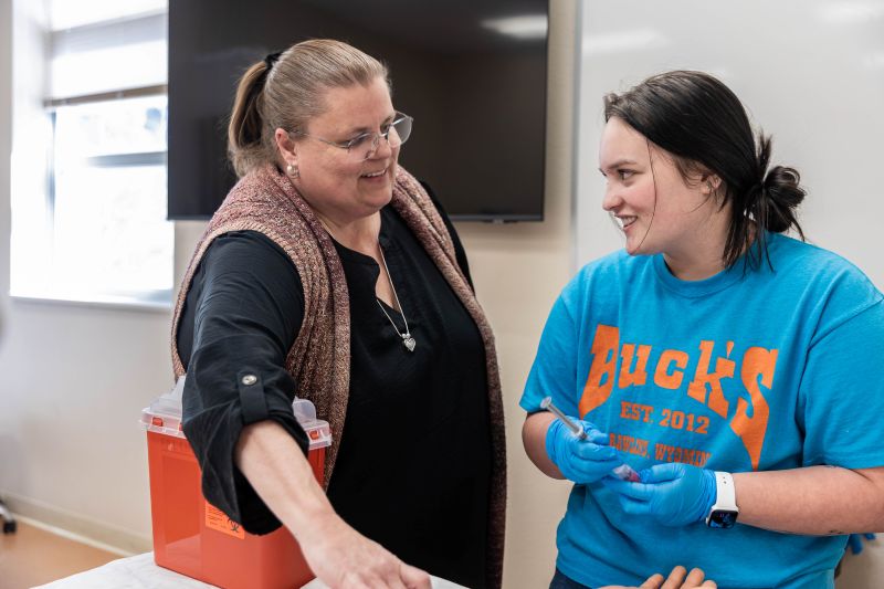 Jennifer Ackerman, LCCC Health Sciences program director, works with a student in a lab.