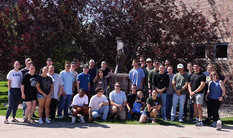 group photo of the F.E. Warren Air Force Base Airman Leadership School in front of the Health Science building on campus
