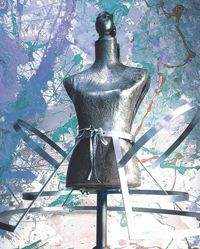 Artwork by Laura Phelps Rogers of a metallic bodice with metal pieces coming off it