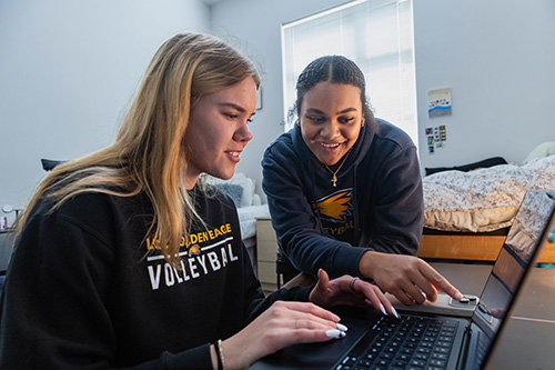 Lea, left, and Zoe, volleyball athletes at LCCC, do homework in their dorm room. 